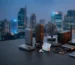 A collection of the Best Gadgets featuring a router, speaker, and power bank on a desk with a night city skyline view.